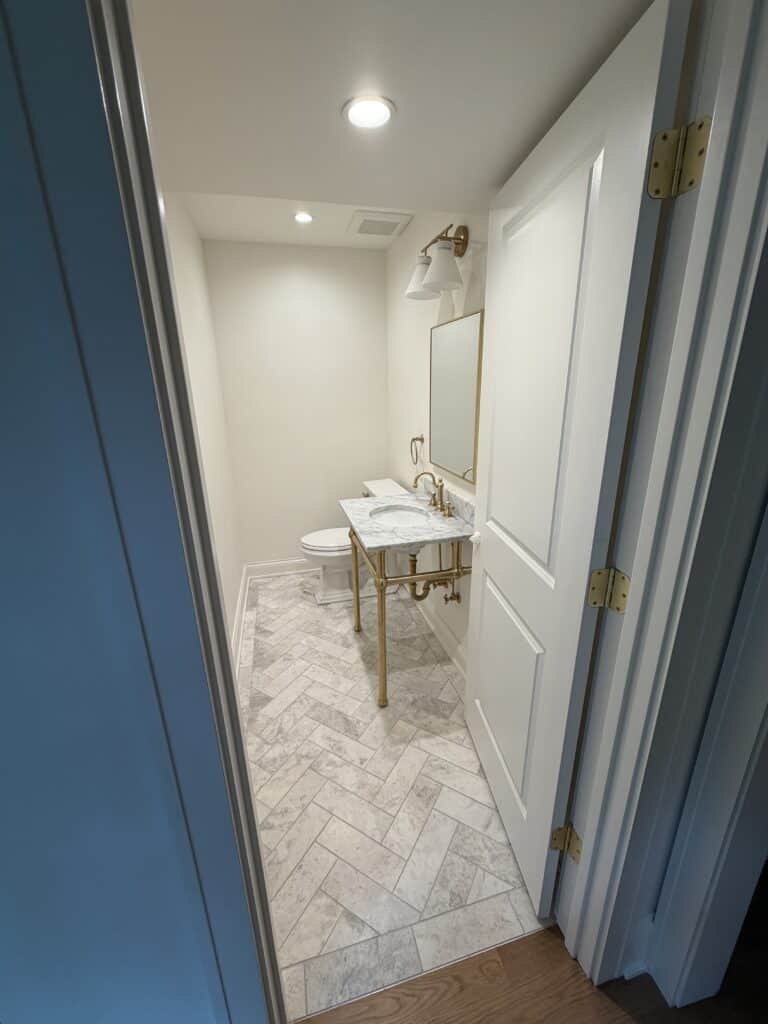 herringbone marble floor powder bathroom