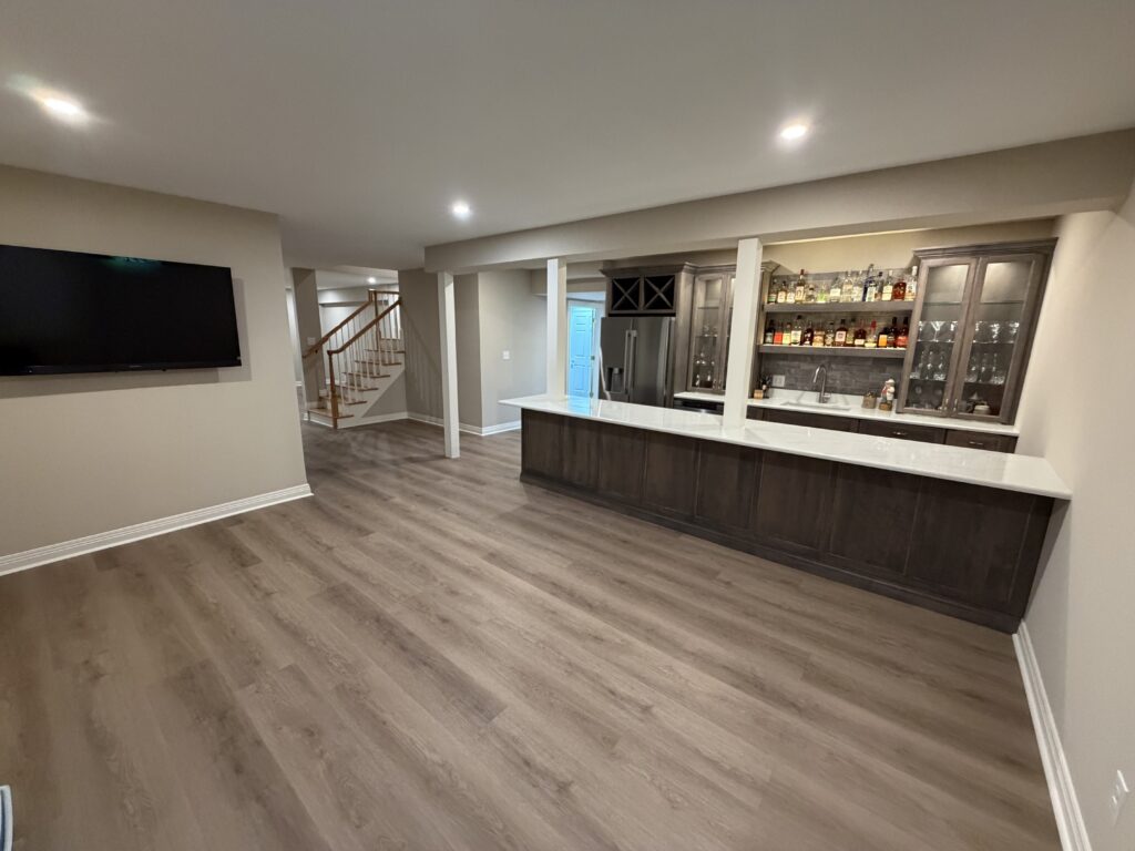 finished basement with kitchenette and bar with lighted shelving
